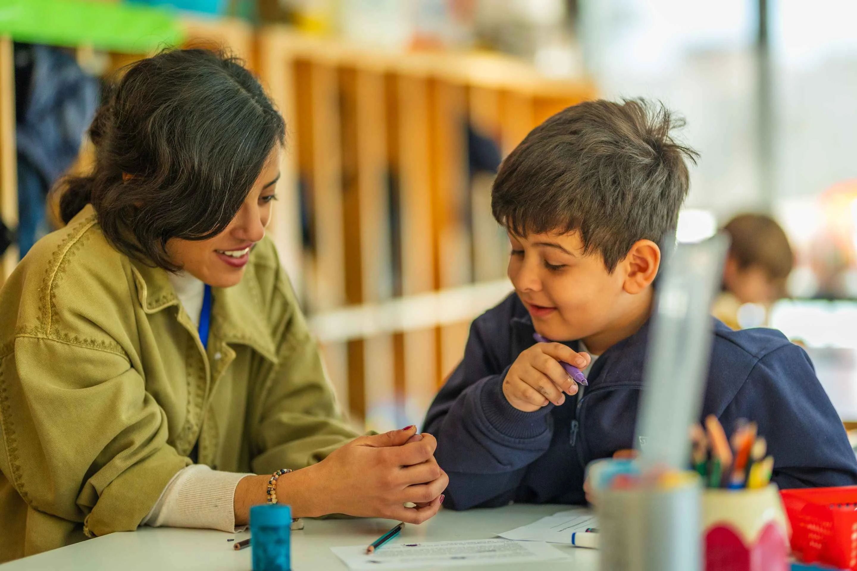 Teacher and student in the classroom smiling