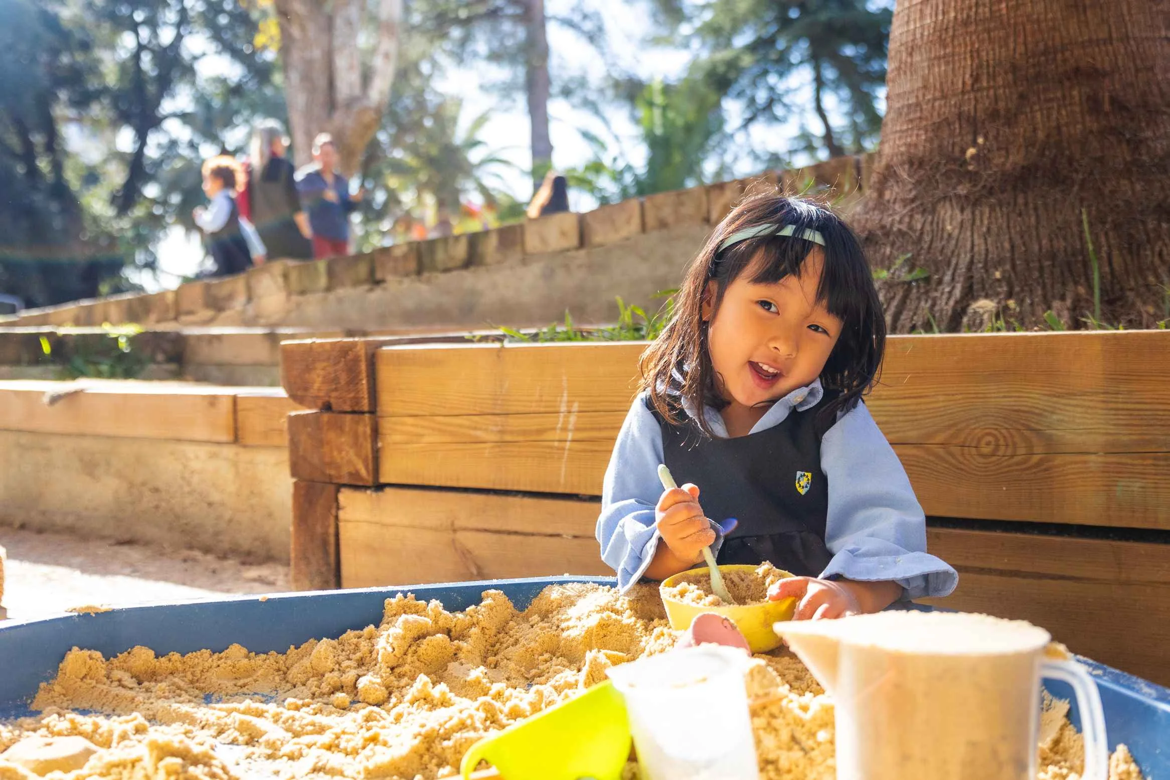 Little girl playing with sand