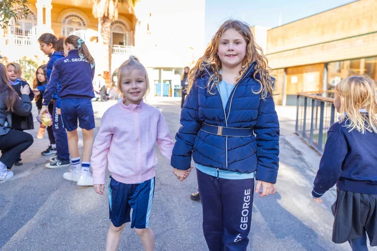 Two students holding hands