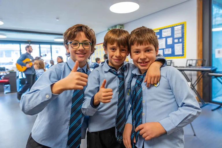 Three students hugging each other
