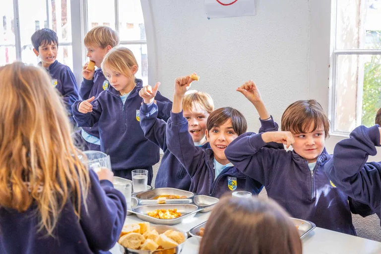 Students eating and smiling in the school canteen