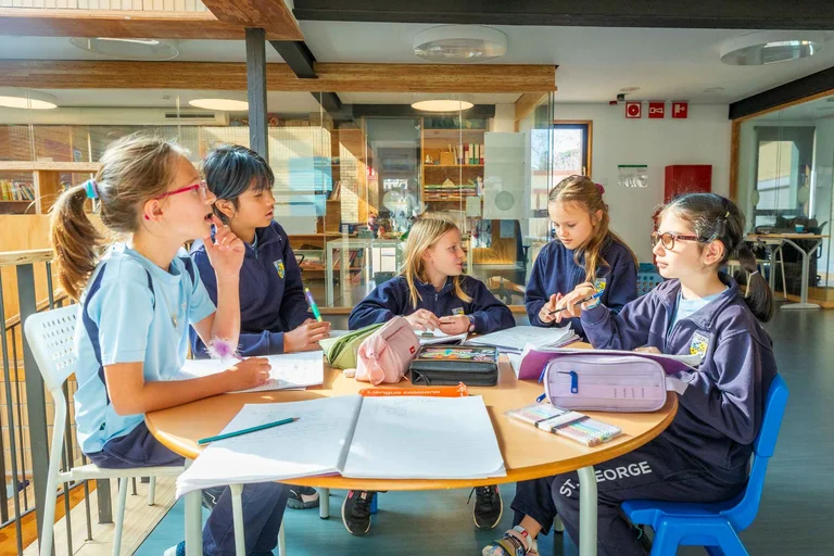 Students in the classroom at the desk 