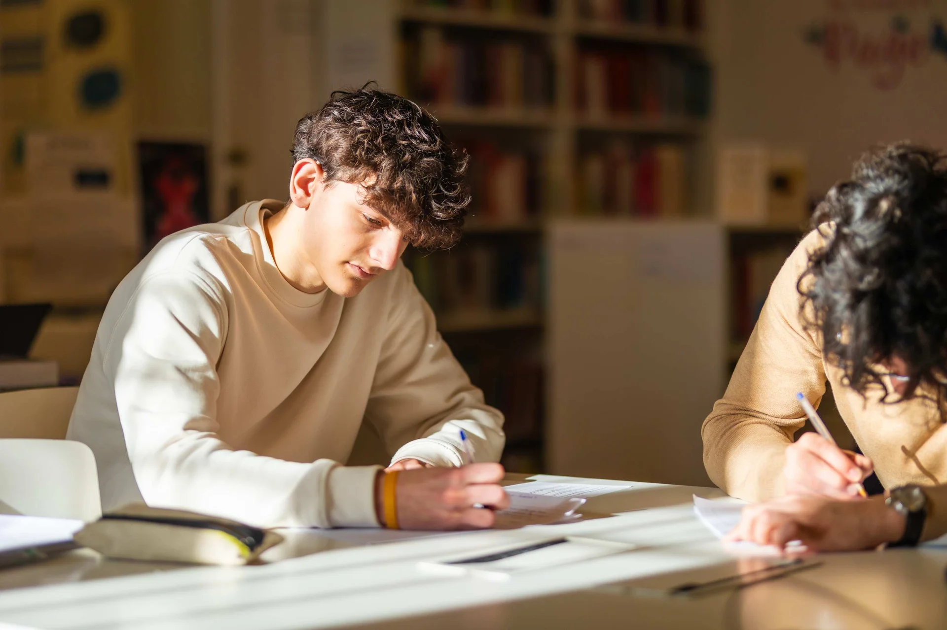 Student writing on a paper 