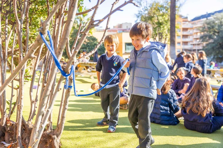 Kids playing with a tree and a rope