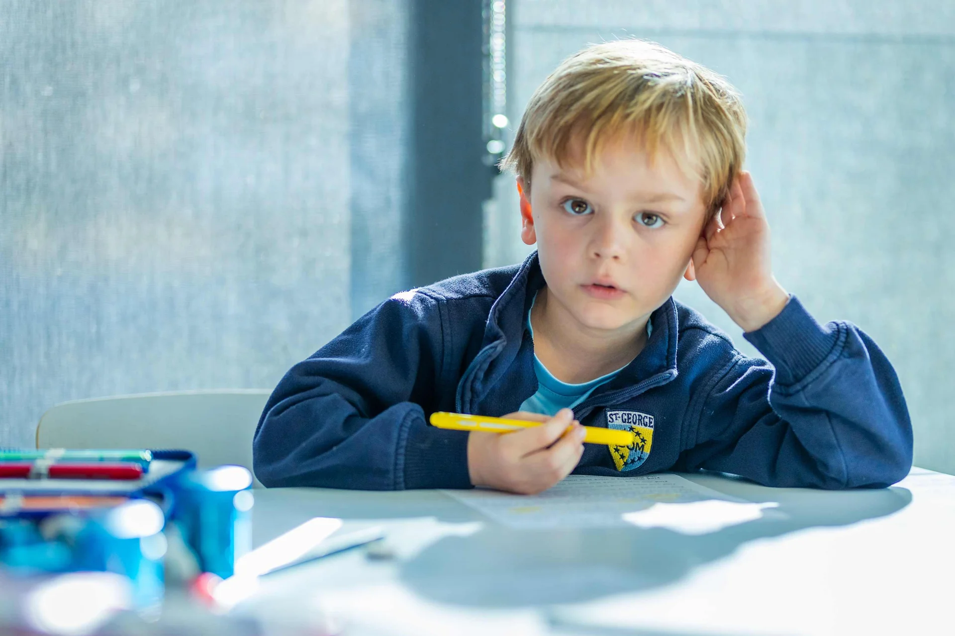 pre school student with a pen in the hand