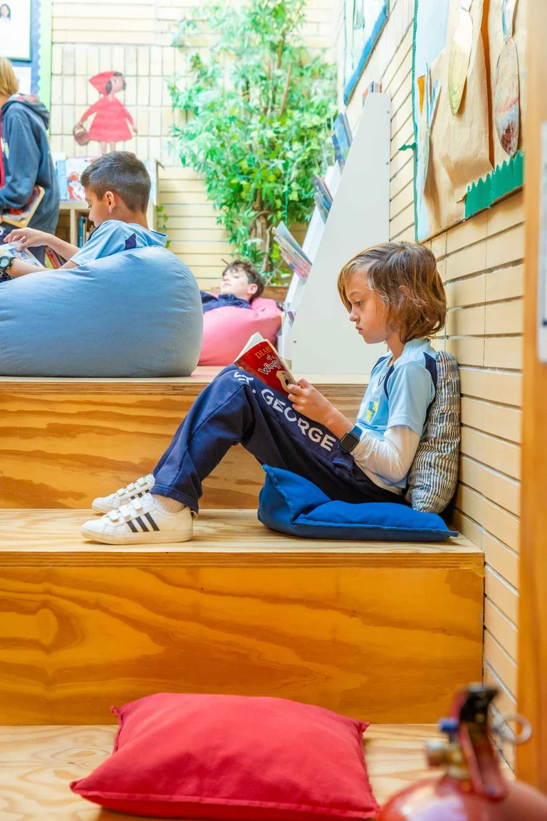 Student reading in the stairs